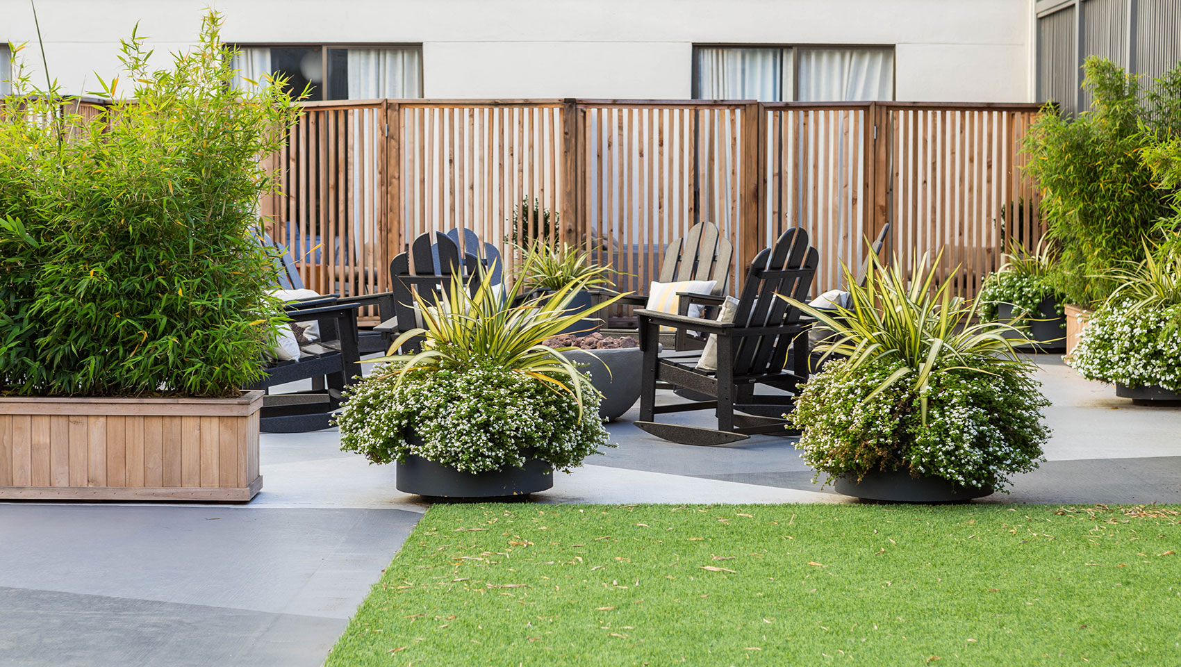 Enso courtyard image with greenery, seating and fire pit